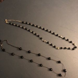 Set of two black necklaces.